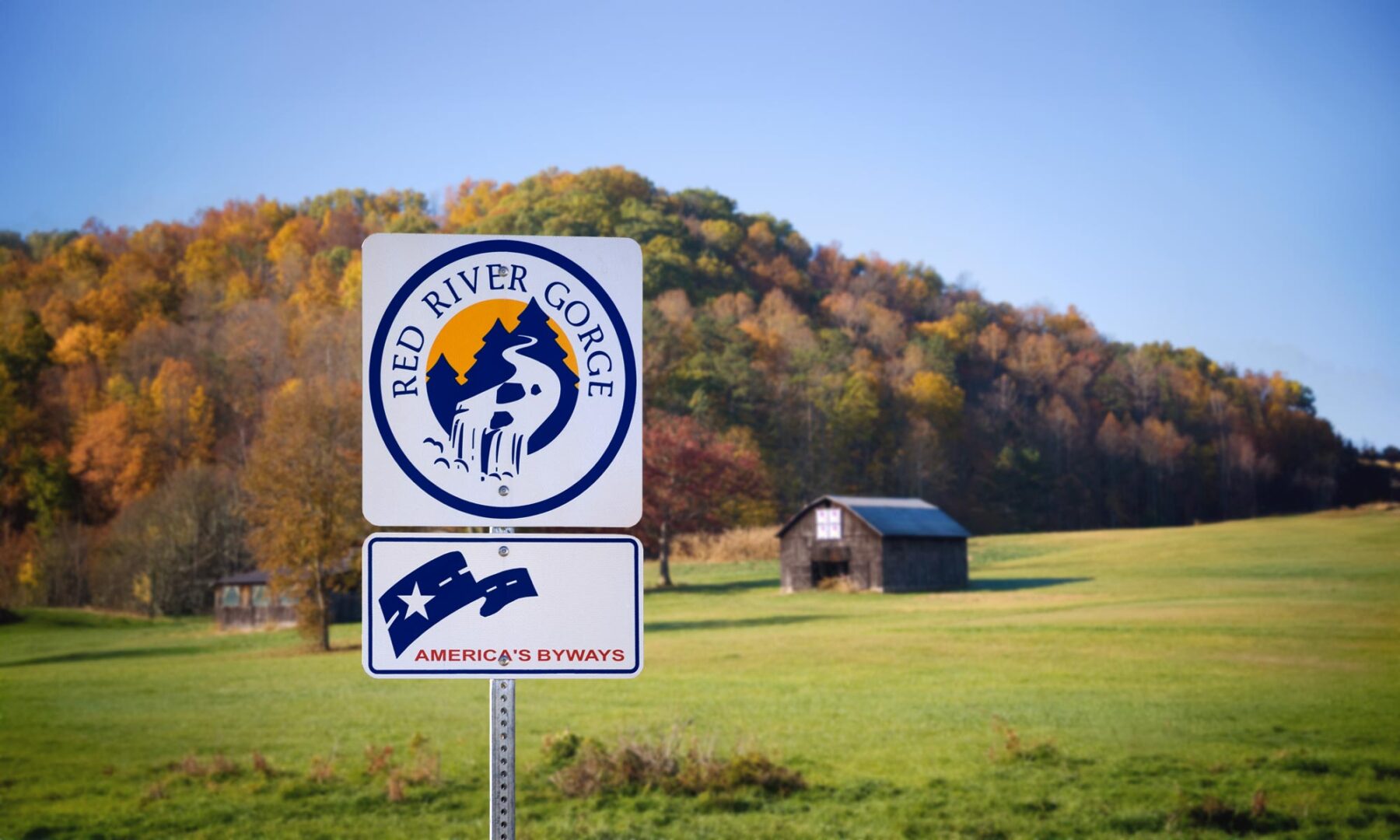 Highway sign in country scenic area with Red River Gourge Gorge and America's Byways text.