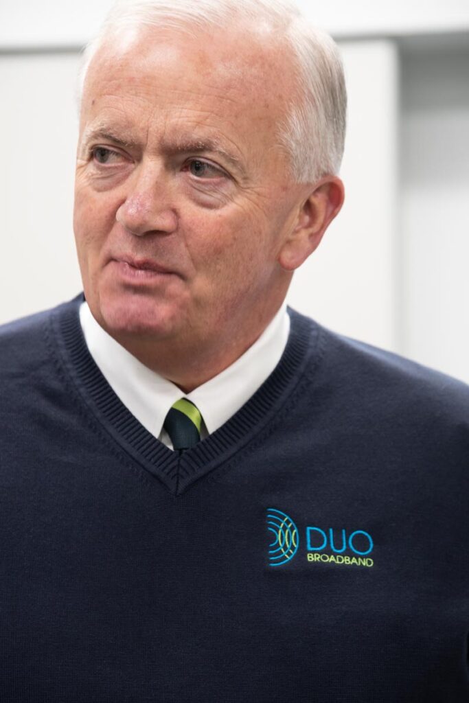 Man with sweater and DUO Broadband logo embroidered.