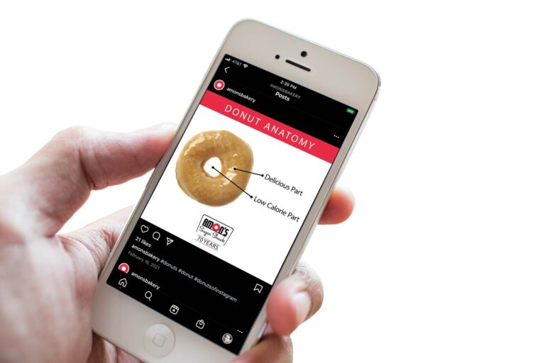 Hand holding smart phone and social post on screen showing a donut and call outs: "Delicious Part" pointing at the donut and "Low Calorie Part" pointing to the hole.