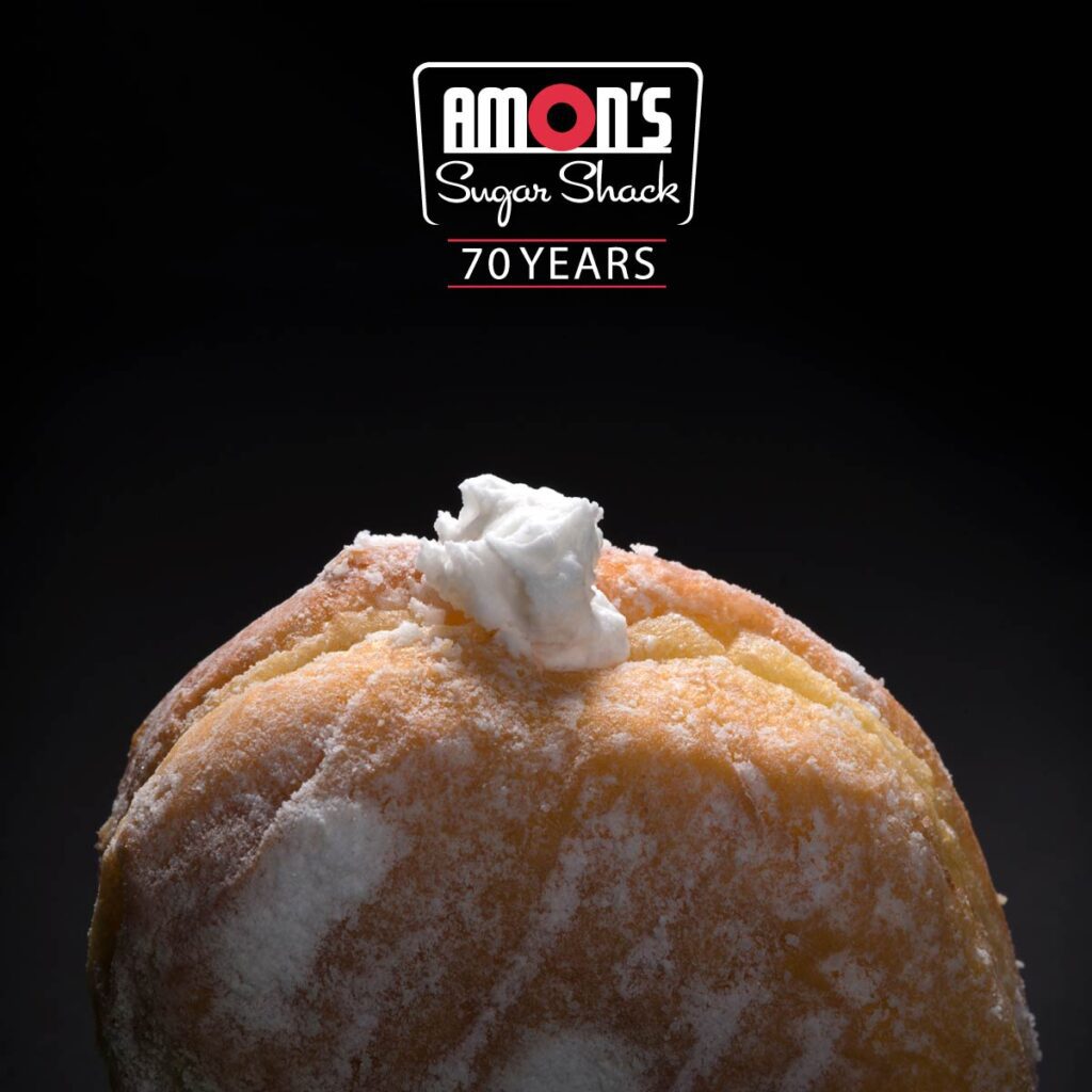 Close up of creme filled donut and amon's logo