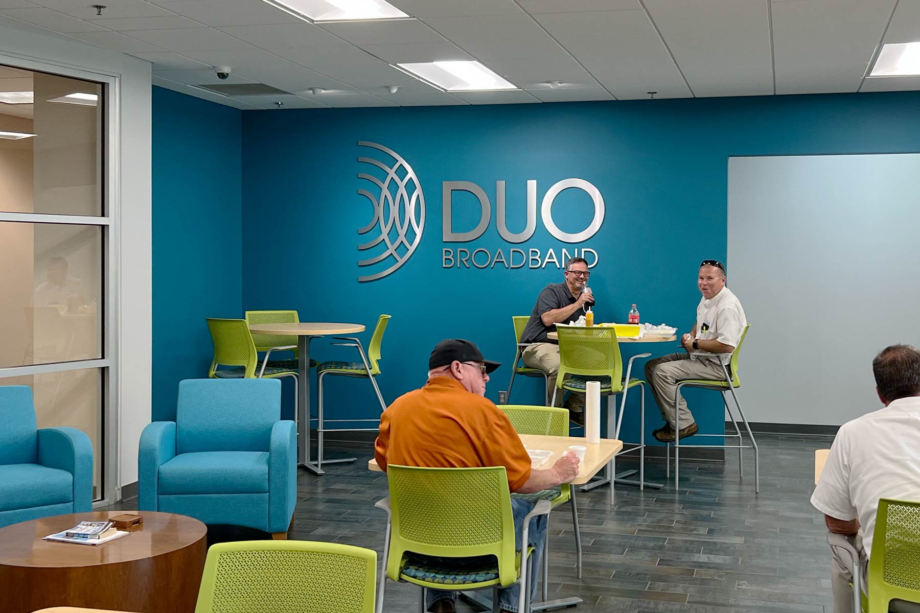 DUO Broadband break room with large logo on the back wall.