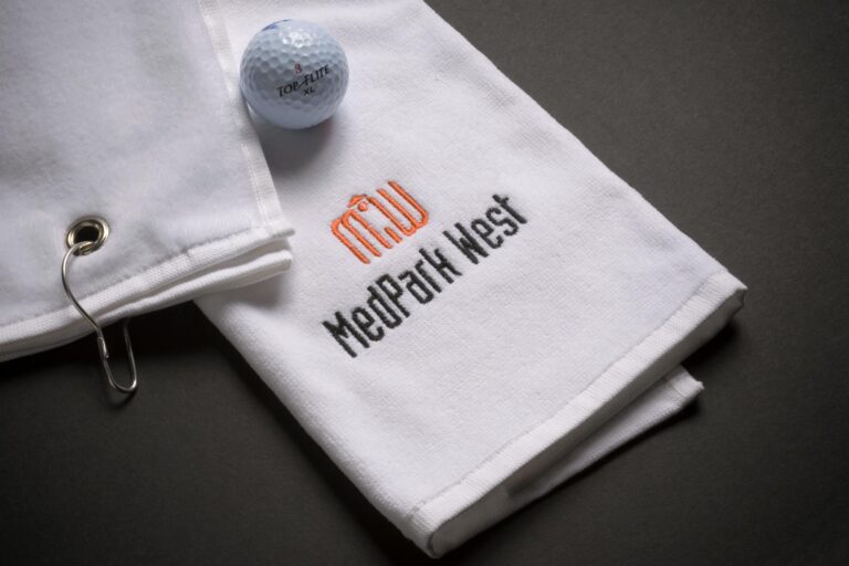 MedPark West branded golf towel with golf ball.