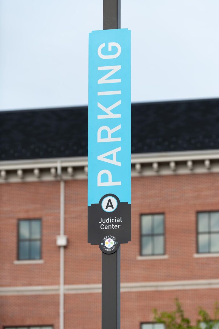 Tall "parking" sign on lamp post.