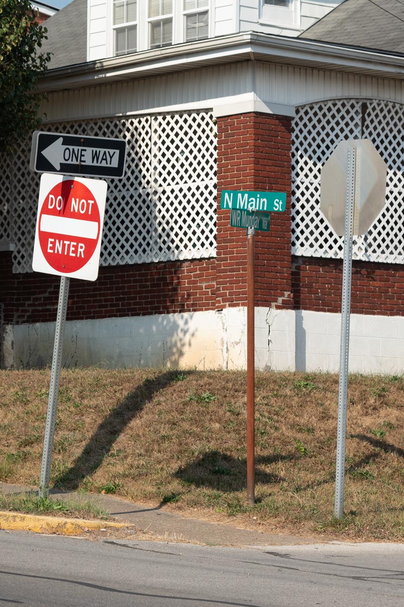 Street corner with three miss matched signs