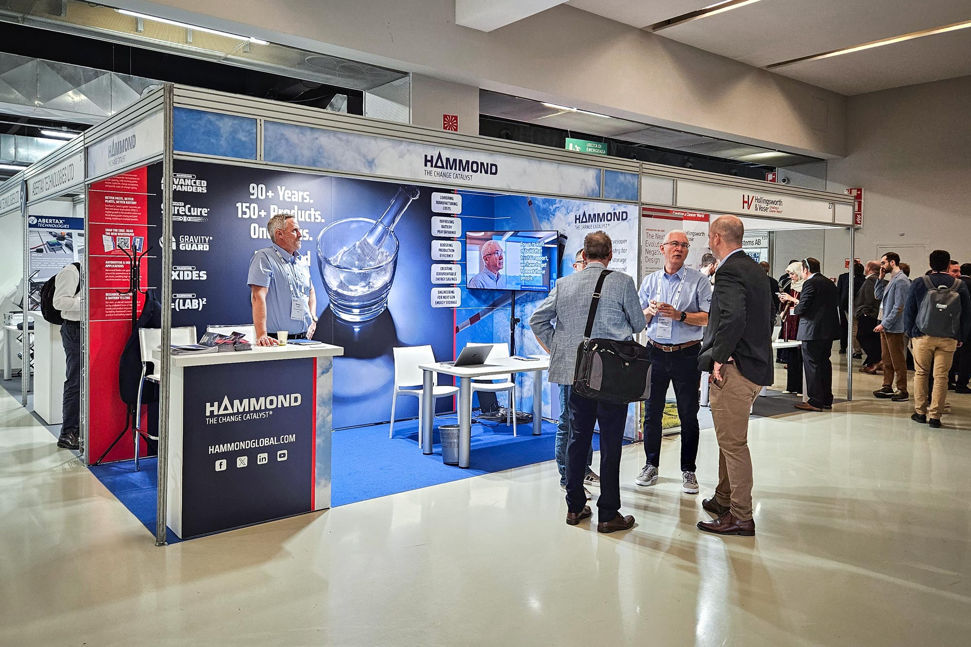 Branded trade show booth with group of people talking