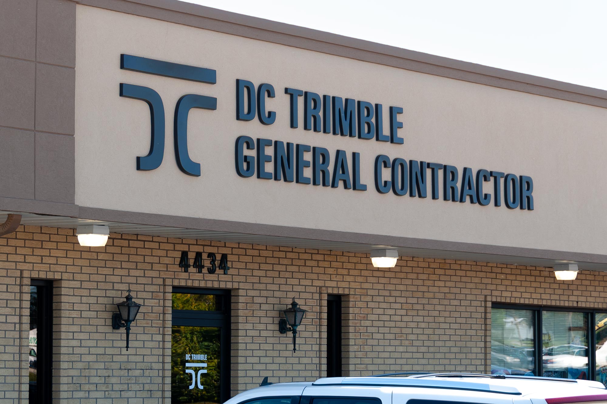 Brick building with dimensional logo and lettering signage for DC Trimble General Contractors