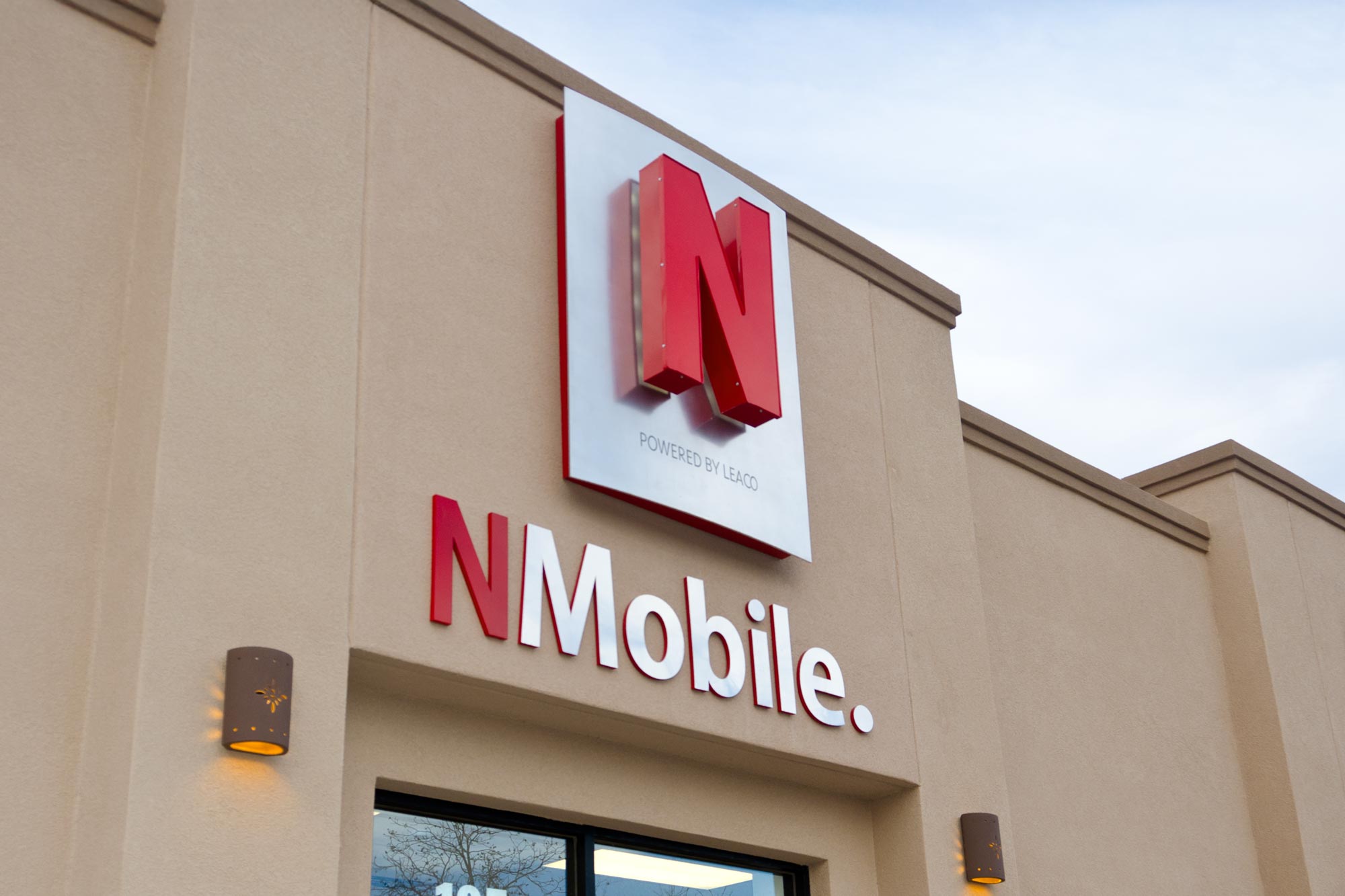 N Mobile exterior building sign with large red "N" logo on silver metal panel