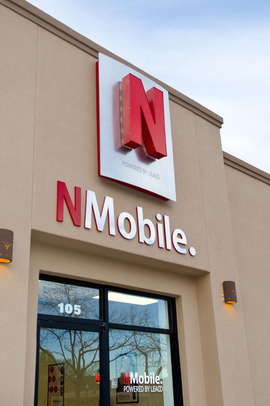 N Mobile exterior building sign with large red "N" logo on silver metal panel