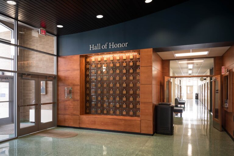 wide view of SCC Hall of Honor dedication panel, glass with wood