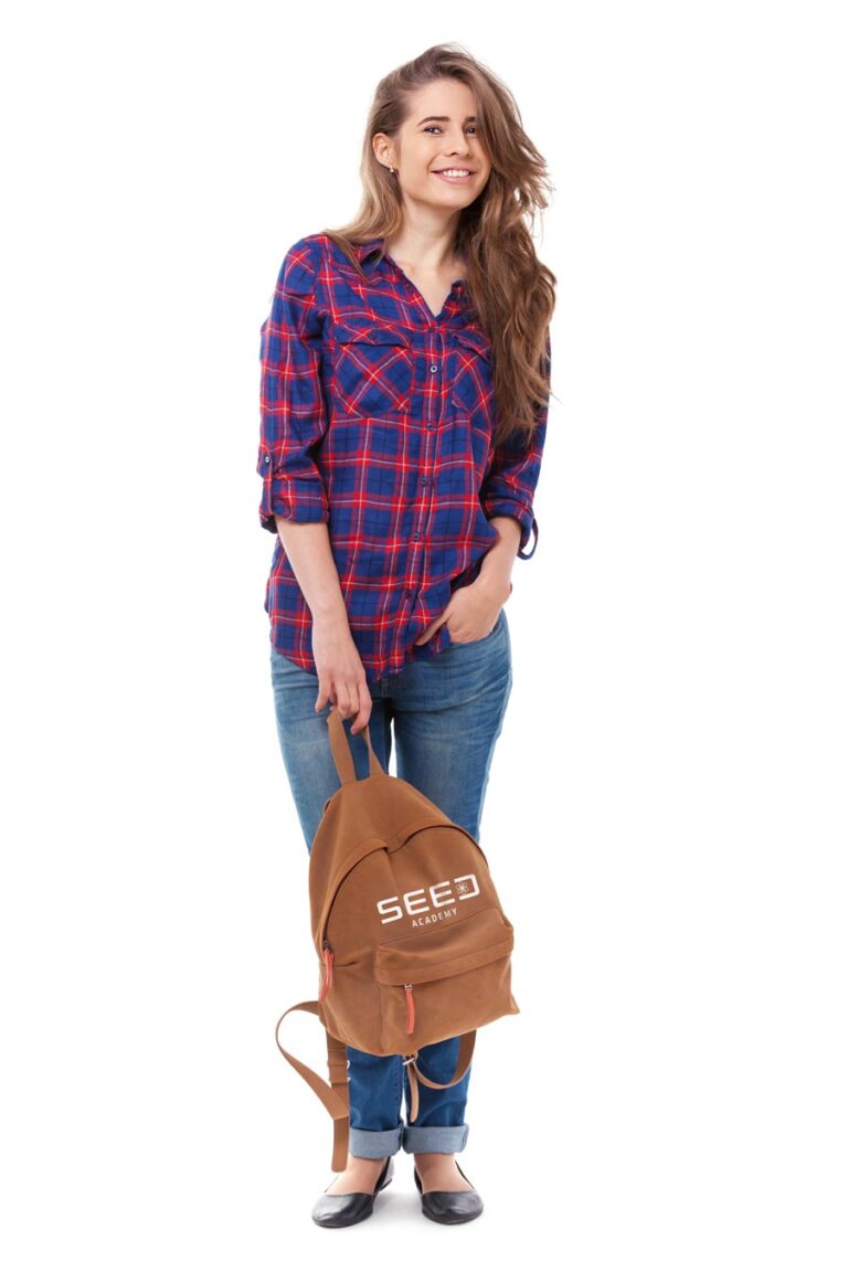 Young woman holding a SEED ACADEMY branded backpack