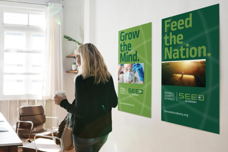 Classroom with teacher and two SEED ACADEMY posters on the wall
