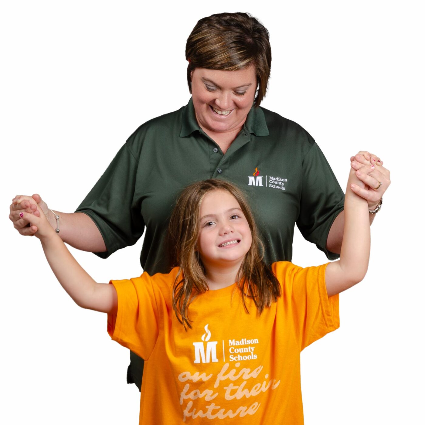 Teacher and young student wearing branded Madison County Schools shirts
