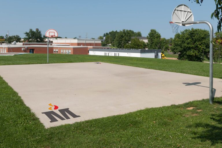 Madison County Schools sysmbol on outdoor basketball court