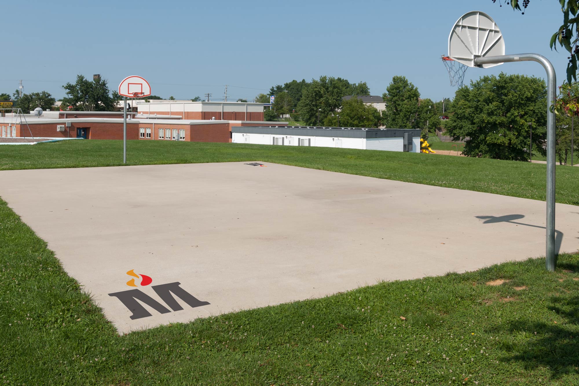 Madison County Schools sysmbol on outdoor basketball court