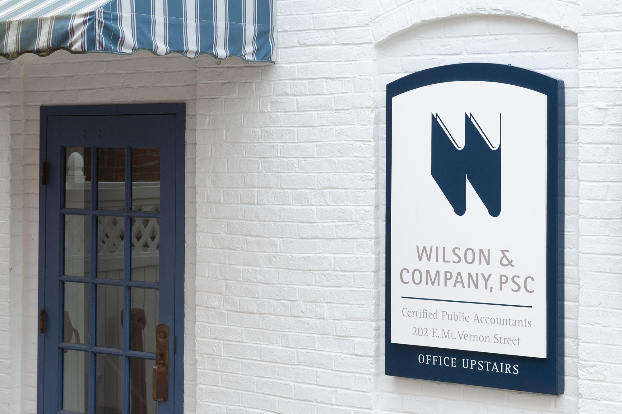 Wilson & Company, PSC exterior sign shaped to fit and architectural recess in the wall.