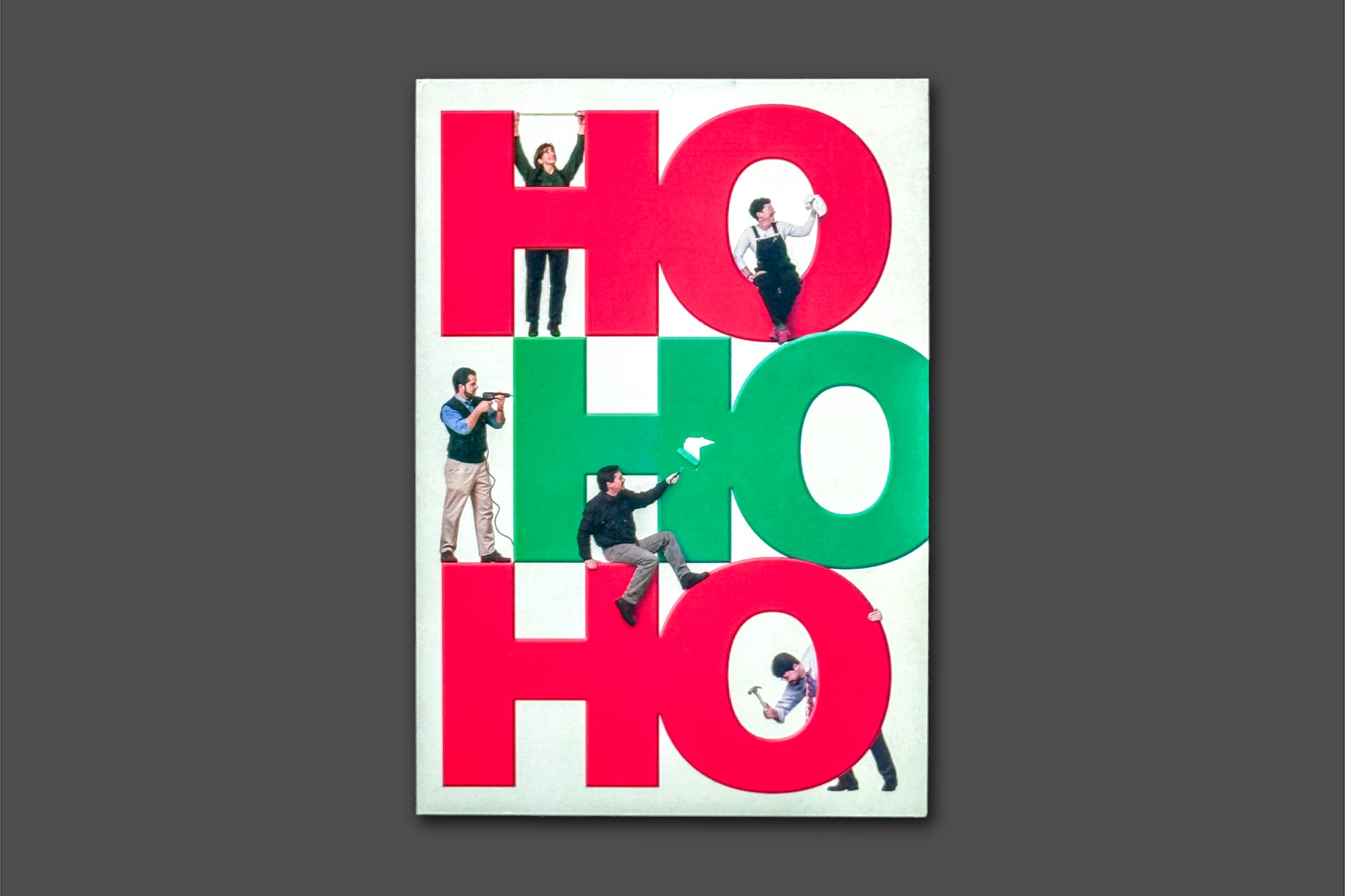 Christmas Card with people standing on the large words HO HO HO with carpentry tools