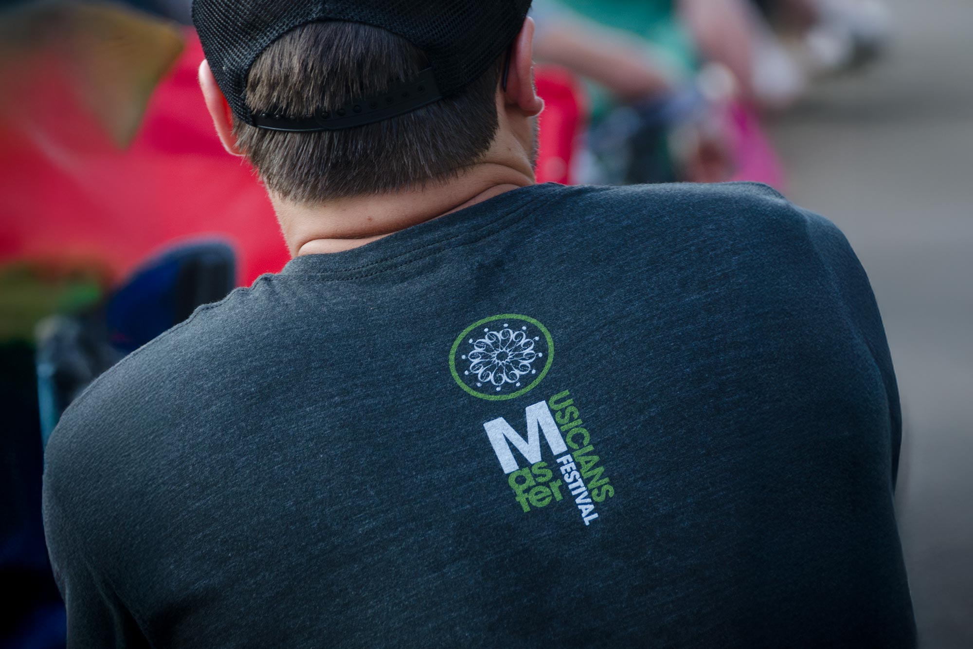 Master Musicians Festival logo on the back of a man's t-shirt