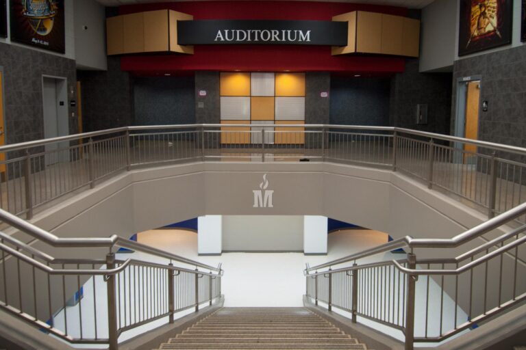 Madison County Schools "M" symbol above the auditorium stairway