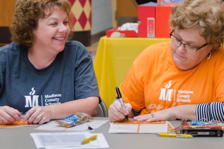 Two teachers with Madison County Schools branded shirts