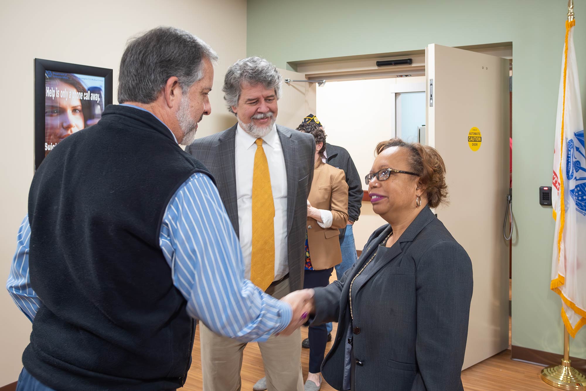 Man shaking woman's hand