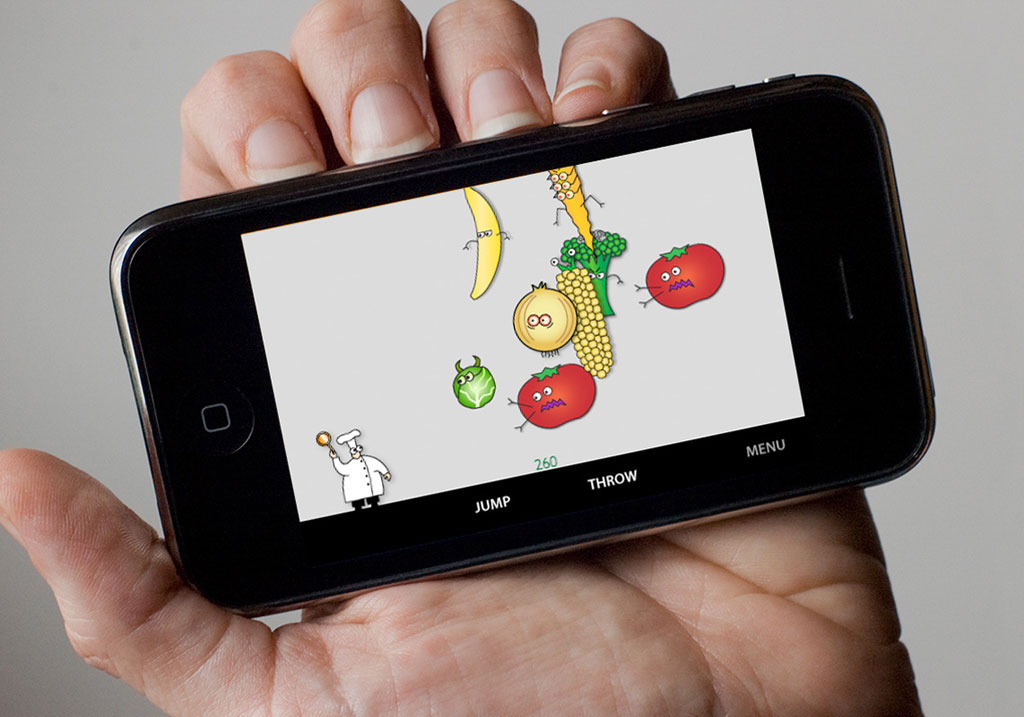 Hand holding an iPhone with the game Food Fight!