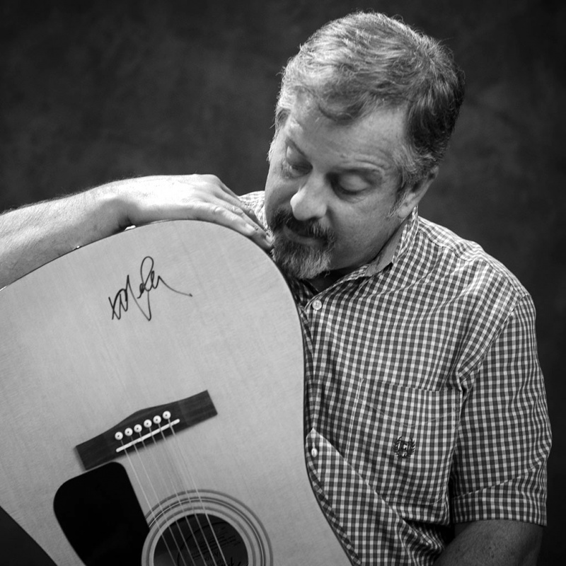 Kirby Stephens holding signed guitar