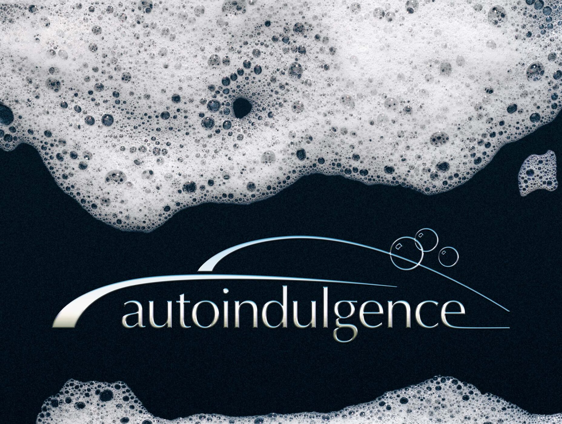 photographic mural with the autoindulgence logo in chrome with foaming suds dripping down.