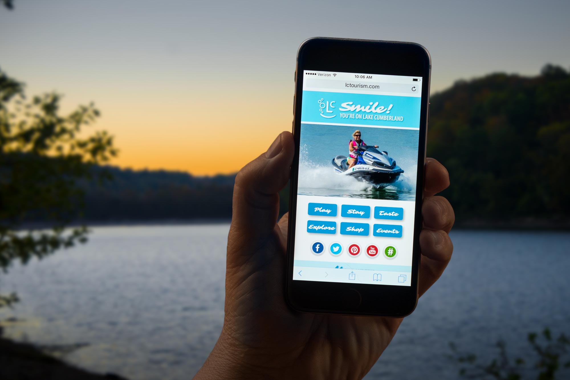 Lake Cumberland Convention and Visitors Bureau website on phone with lake in background