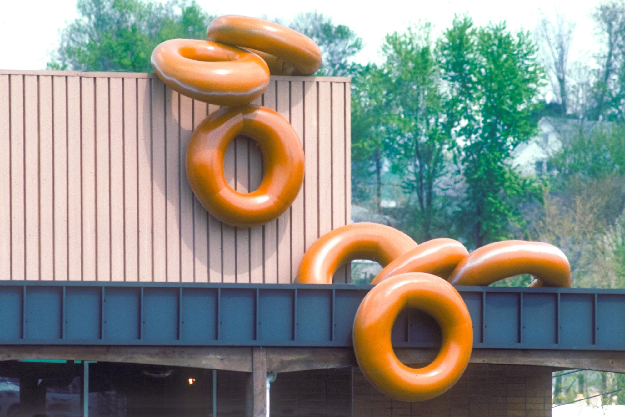 Amon's Bakery with Large donuts spliing from the roof. Inter tubes pained to look like glazed