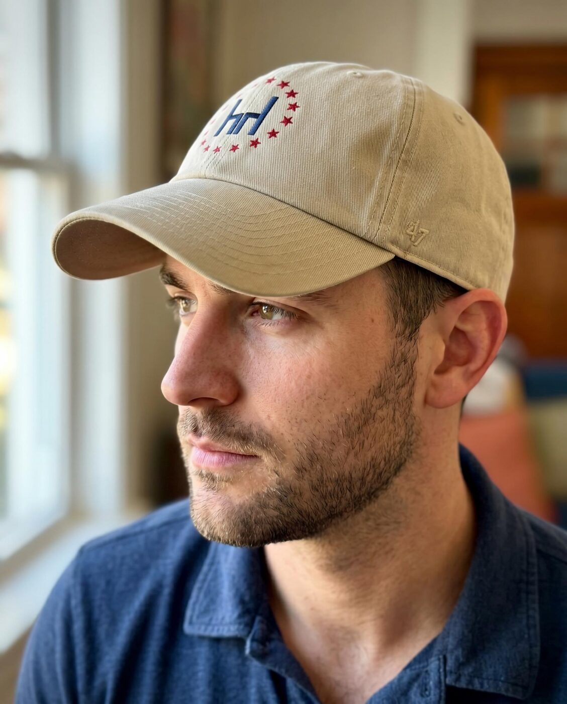 Man wearing a Harrodsburg logo cap