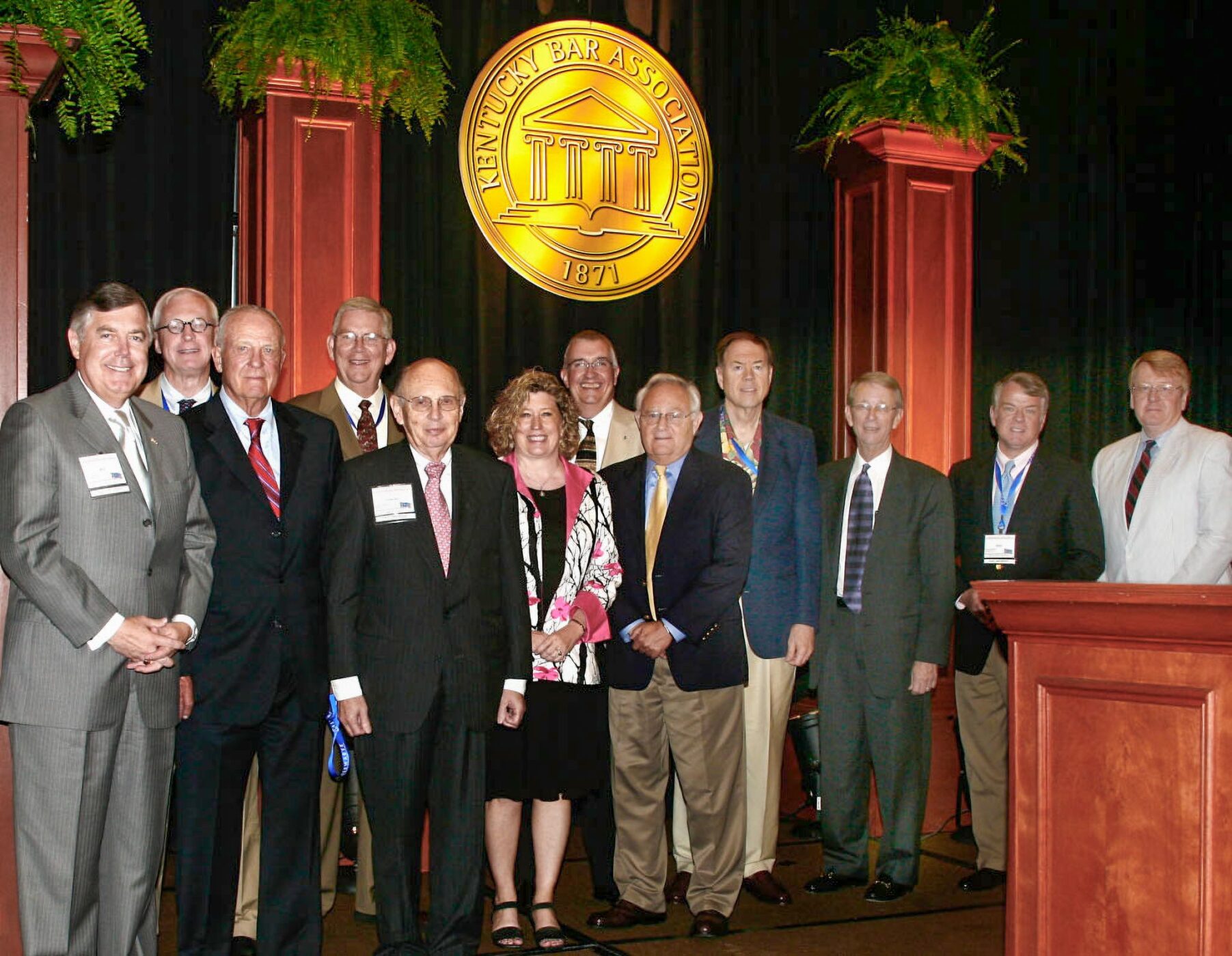 group of 12 people posing for a photograph in front of a Kentucky Bar Association logo