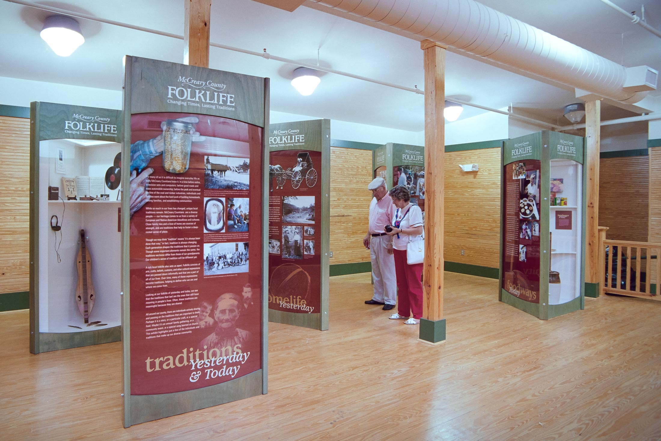 people looking at the McCreary County Folklife exhibit kiosks