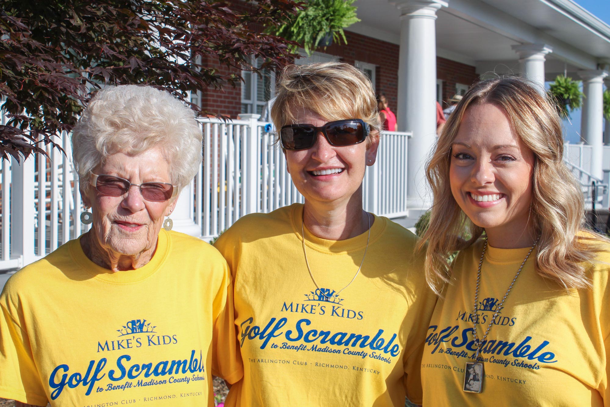 3 women wearing Mike's Kids Golf Scramble t-shirts