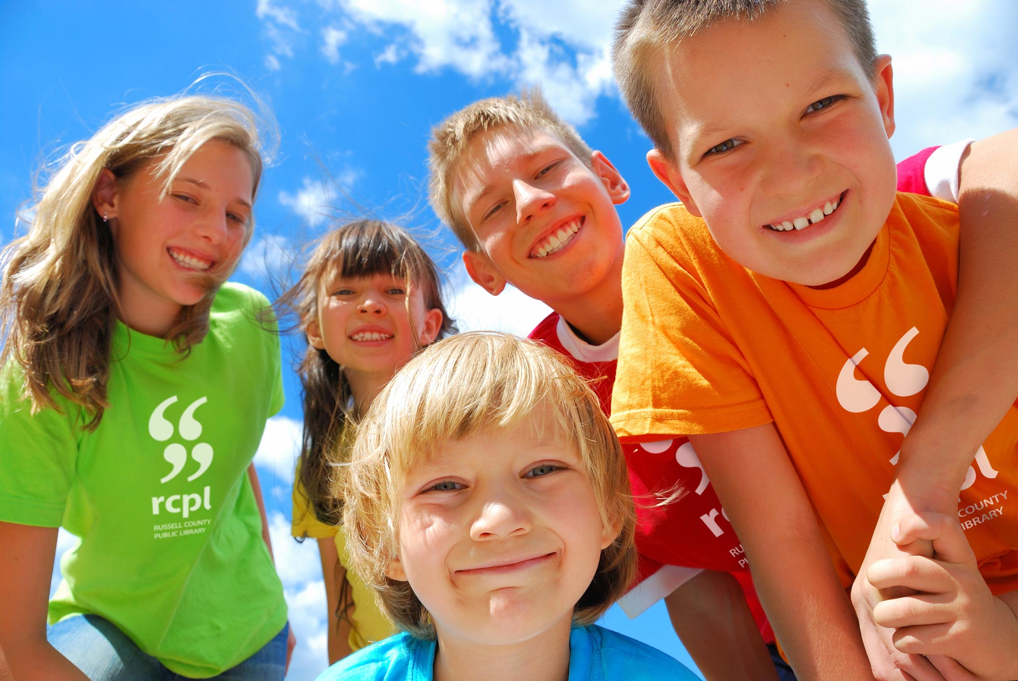 Group of kids wearing Russell County Public Library t-shirts