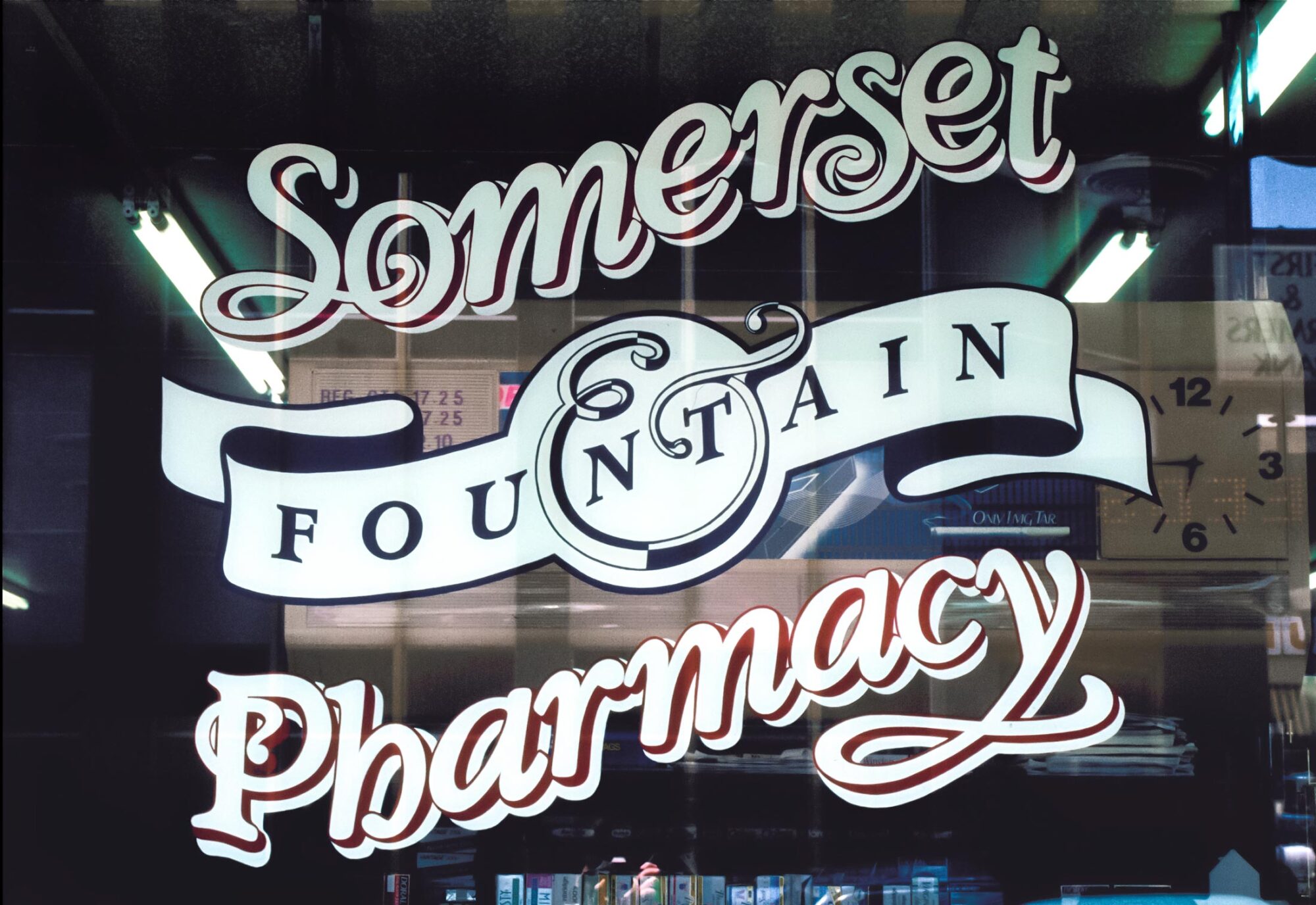 Somerset Fountain & Fharmacy logo sign on glass window