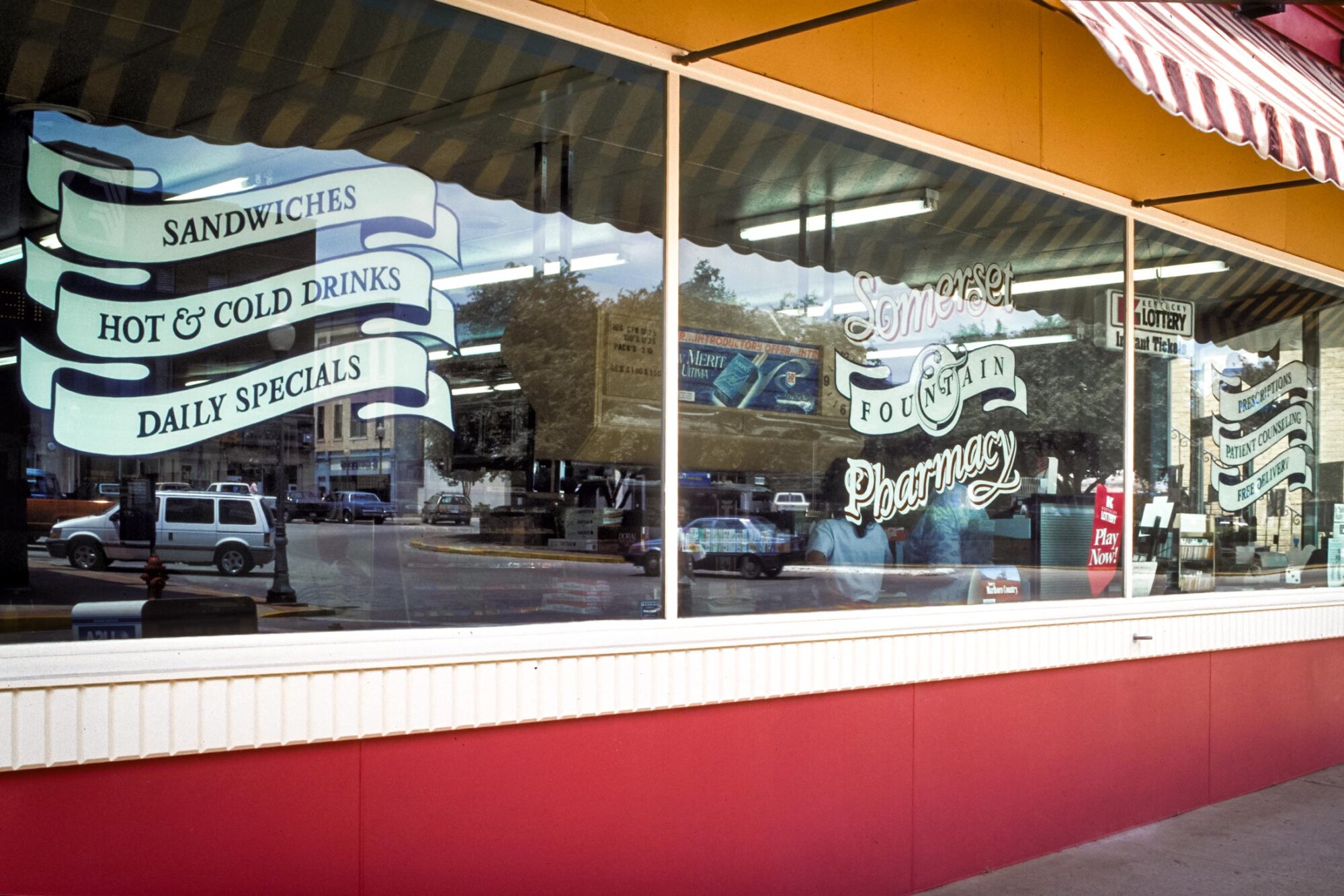 Somerset Fountain & Pharmacy logo sign on glass window
