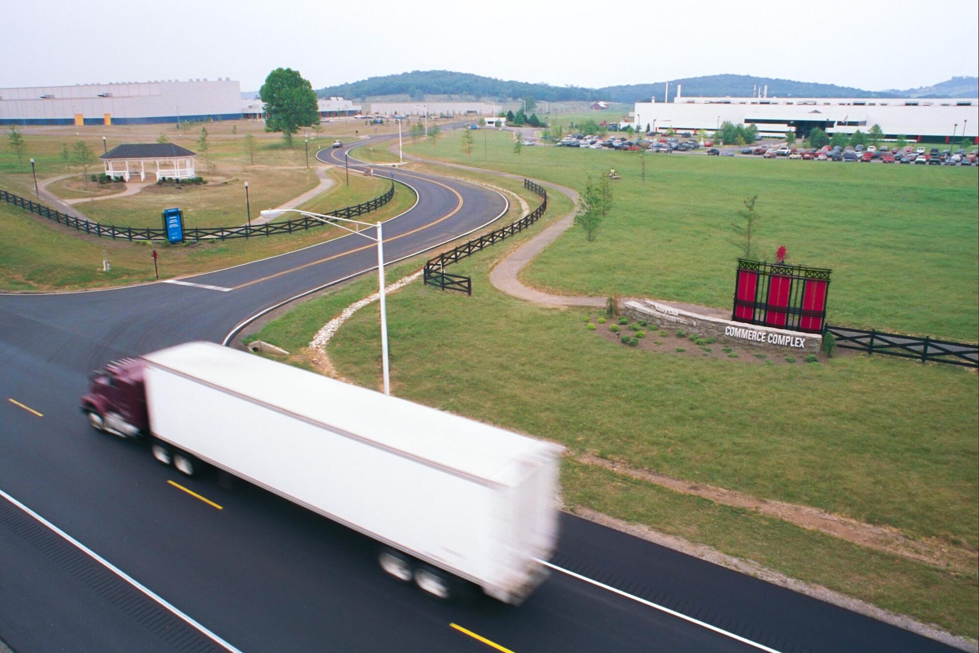 Valley Oak Commerce Complex park entrance with passing semi truck