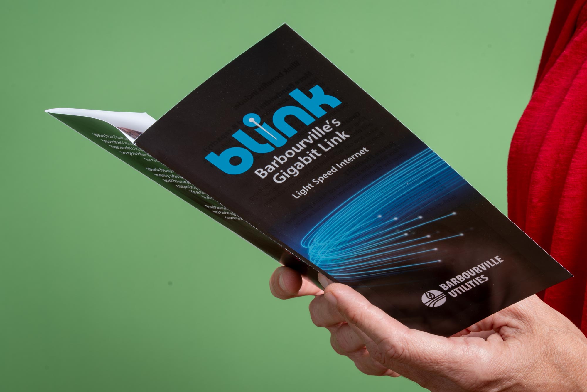 Hands holding open a Blink, Barbourville's Gigabit Link brochure