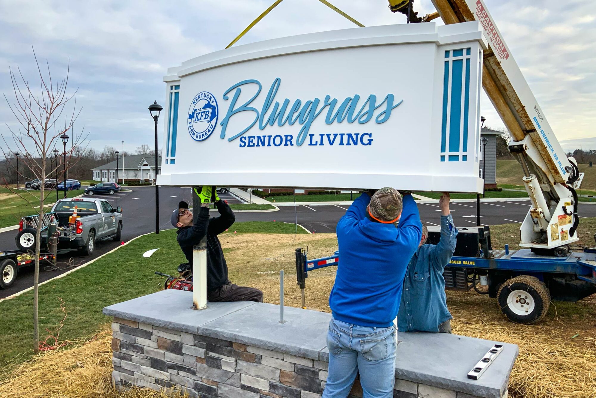 Bluegrass Senior Living entrance sign being installed with crane.
