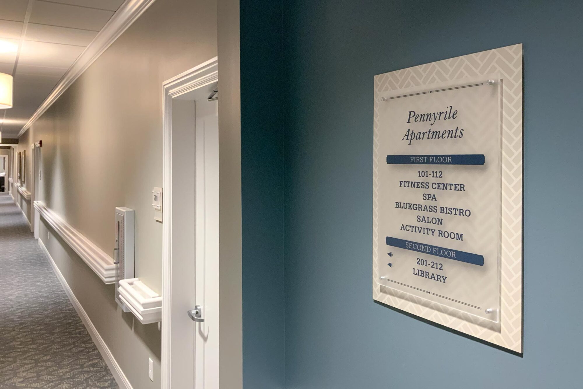 Interior directional sign in hallway