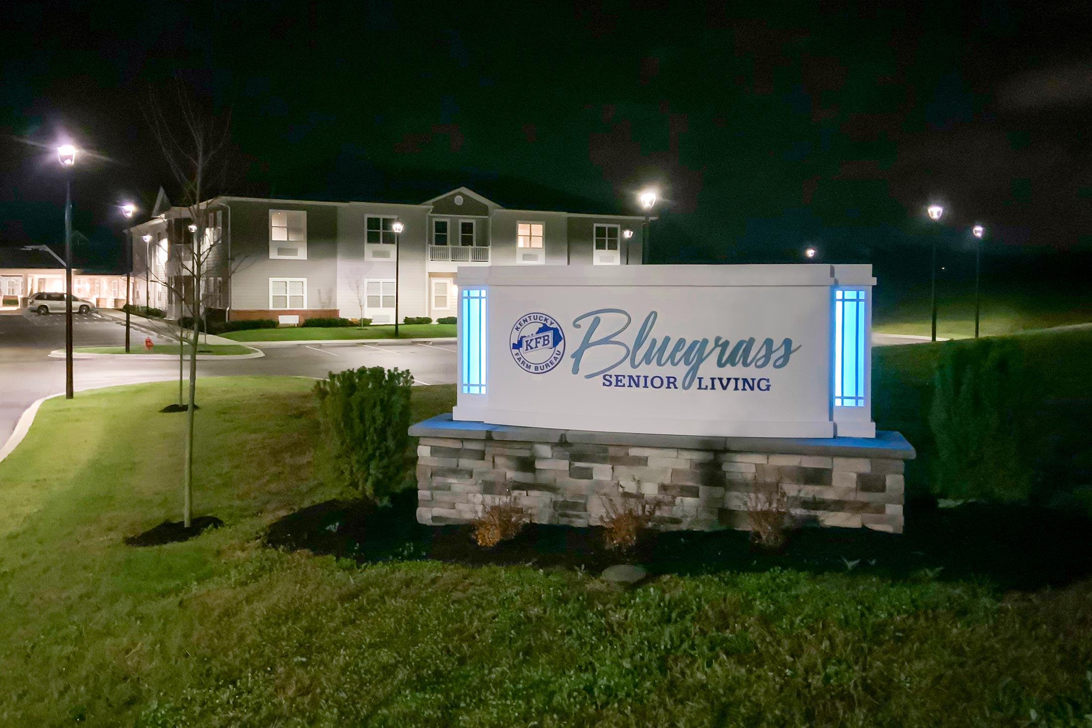 Bluegrass Senior Living sign at night.