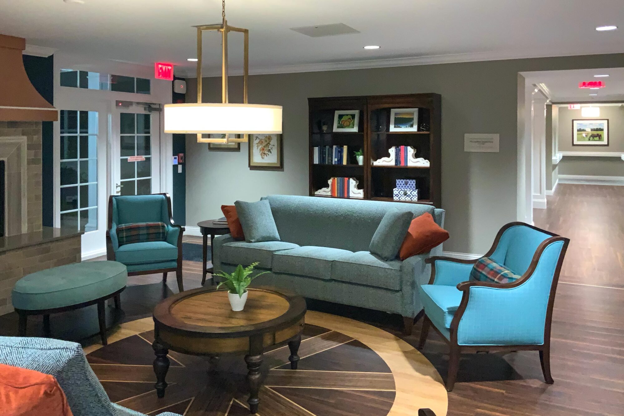 Interior living room with chairs, table, and bookshelf
