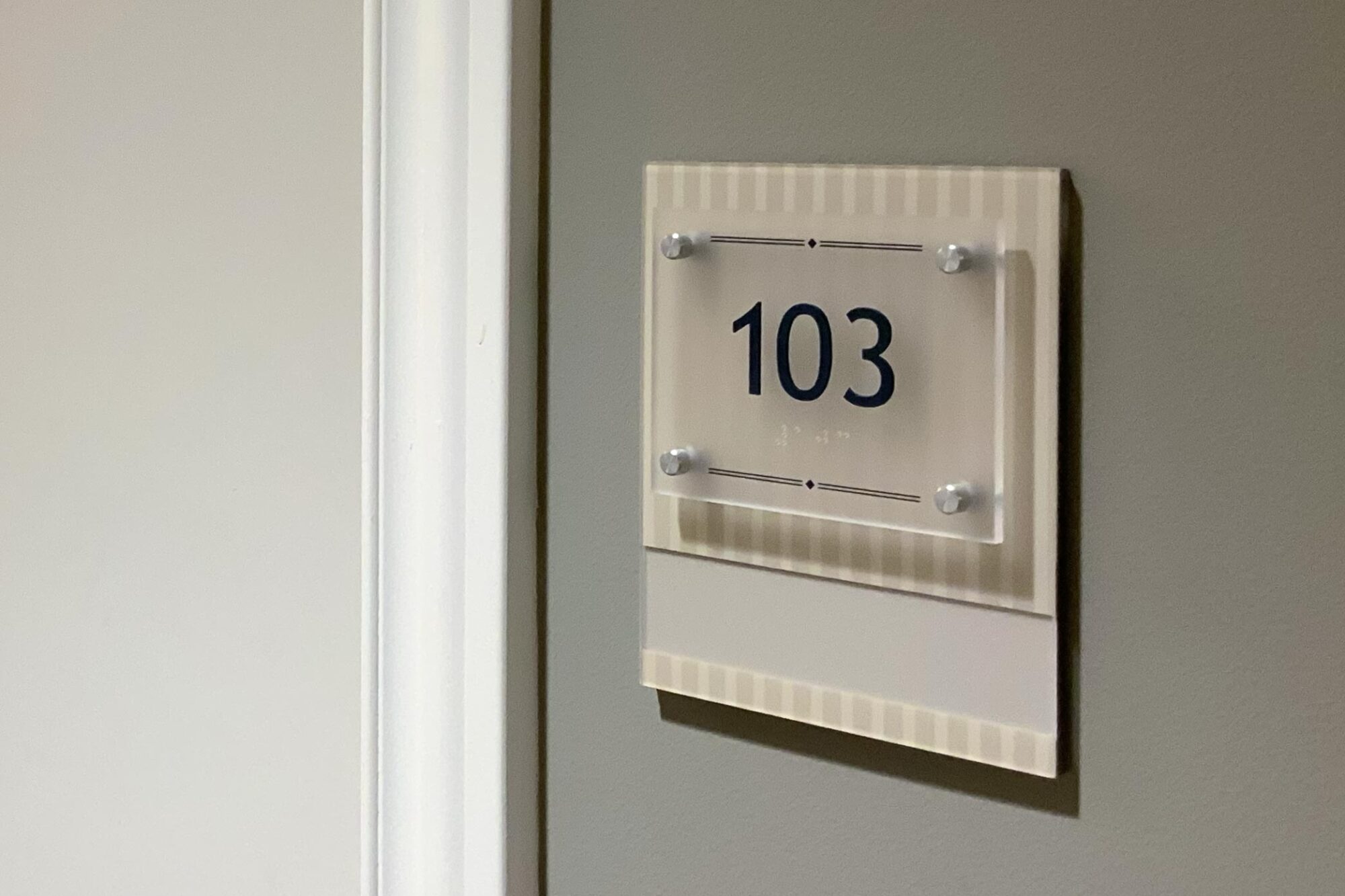 Bluegrass Senior Living sign interior room number.