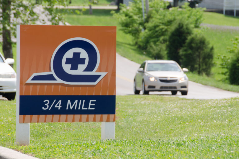 road sign showing distance to clinic