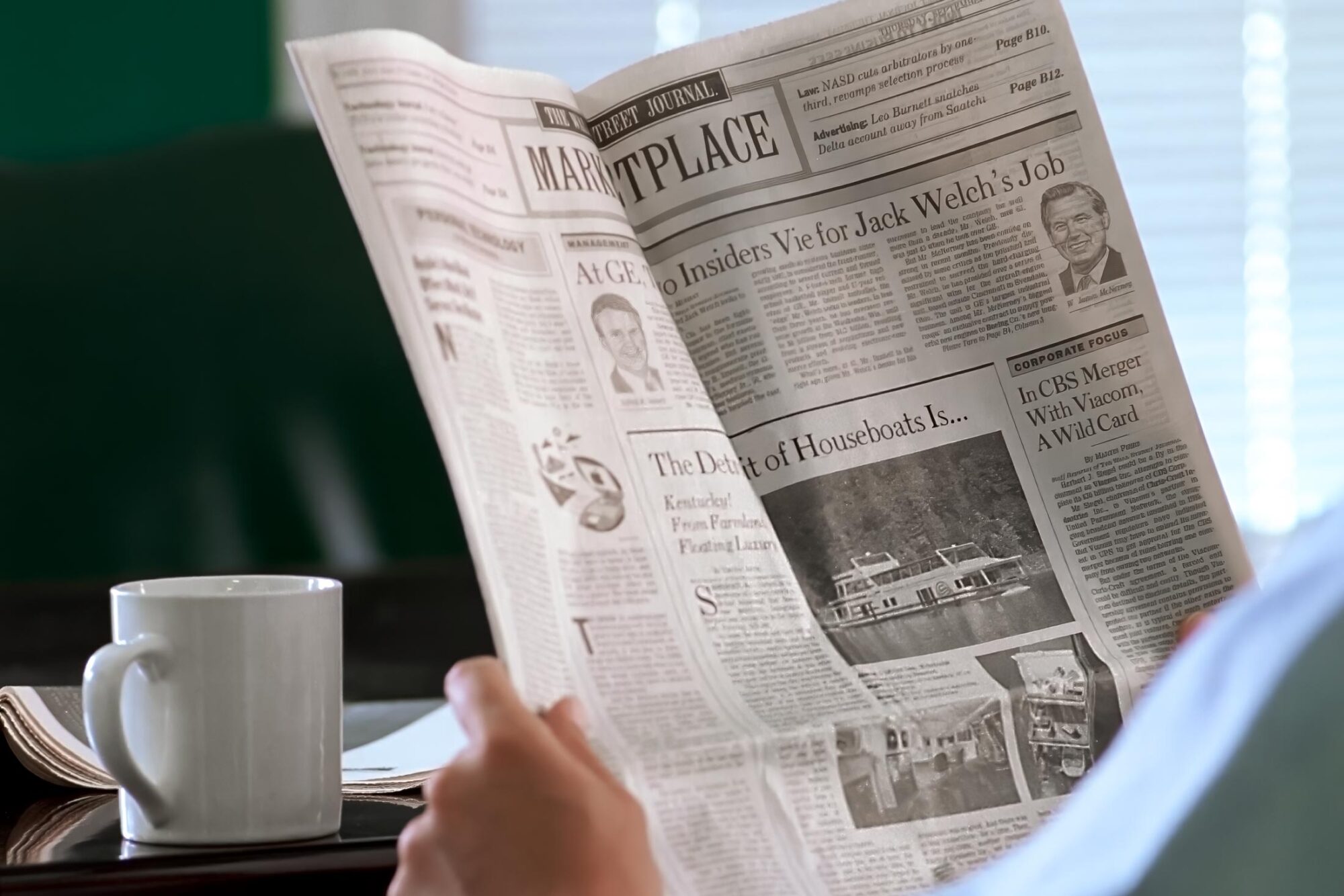 Person reading Wall Street Journal newspaper with Sumerset Houseboats story and photos.
