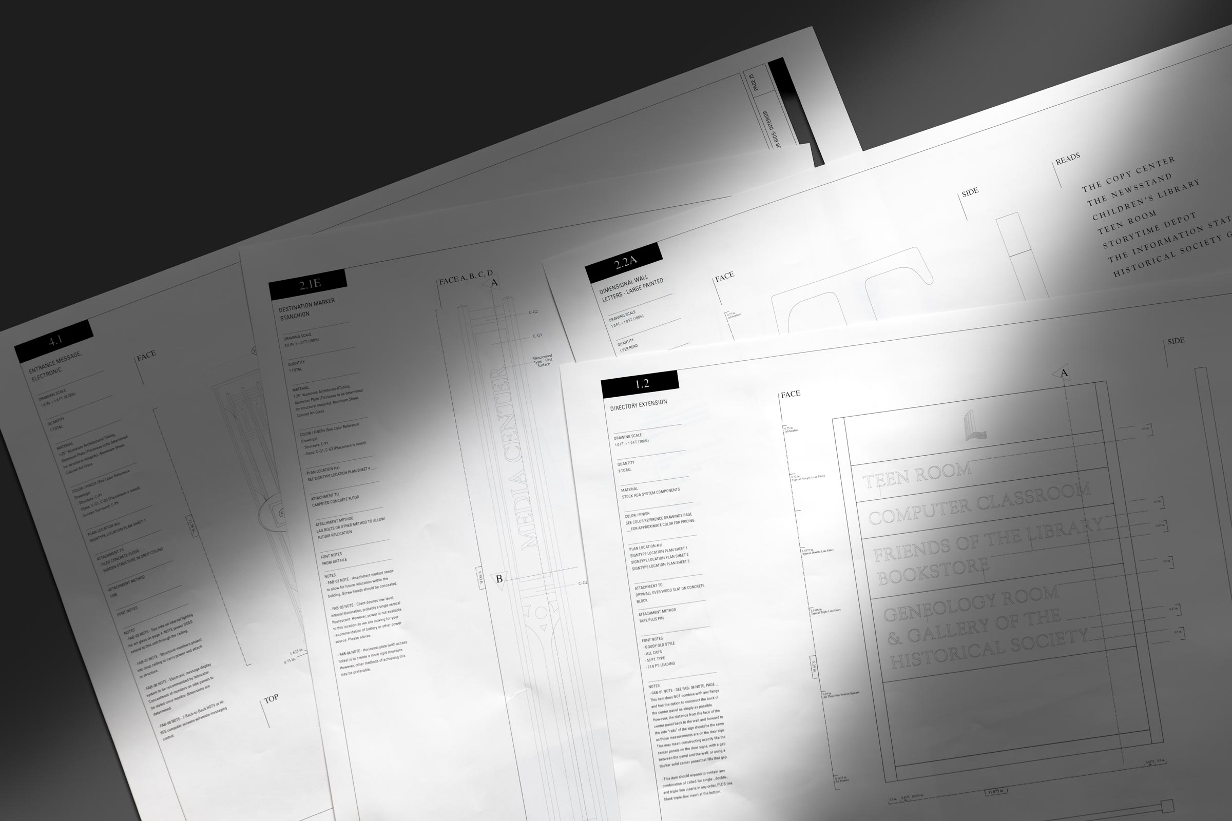 a stack of plans for the Pulaski County Public Library signage system.